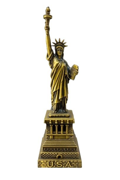 Design: A meticulous miniature capturing the iconic "Liberty Enlightening the World" pose, including the seven-pointed crown, raised torch, and legal tablet.Finish: Features an antique bronze or golden metallic finish, giving it a sophisticated, timeless look suitable for home or office decor.Pedestal: The statue stands on a multi-tiered, architectural base embossed with "U.S.A." at the bottom, mimicking the original monument’s pedestal.Symbolism: This piece represents core American ideals including freedom, democracy, and enlightenment Statue of Liberty Replica